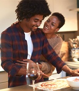 happy healthy couple hugging in kitchen