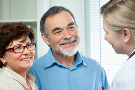 couple consulting female doctor