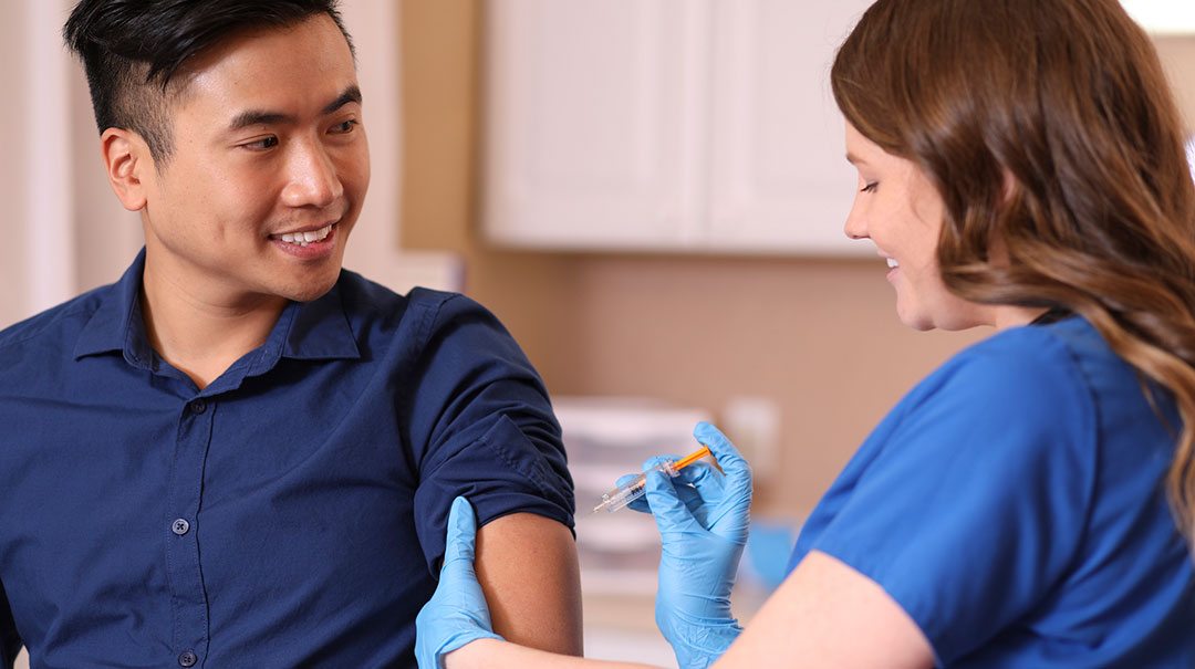 desktop-Doctor-or-nurse-gives-vaccine-shot-to-adult-patient-in-clinic-office-GettyImages-1171330542