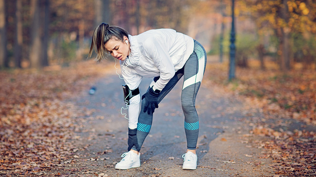 desktop-GettyImages-936322978-runner-running-woman-female-outside-outdoor-forest-woods-workout-exercise-sports-injury-ankle-leg-fracture