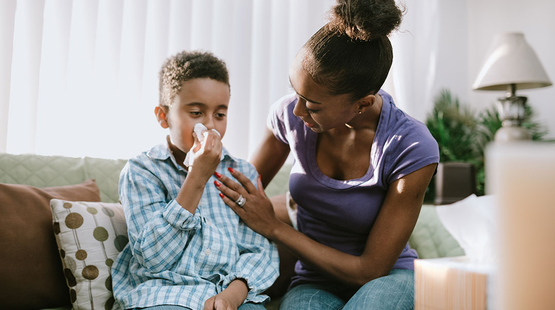 desktop-Mother-Comforts-Sick-Child-With-Cold-GettyImages-1060878080