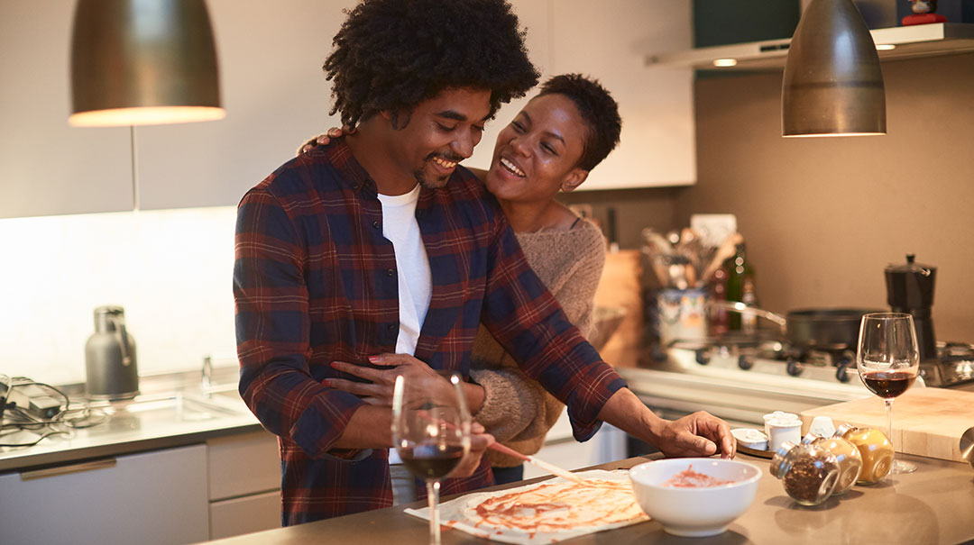 desktop_Couple-hugging-cooking-at-home_celebrating-Valentines-Day_GettyImages-1126461012