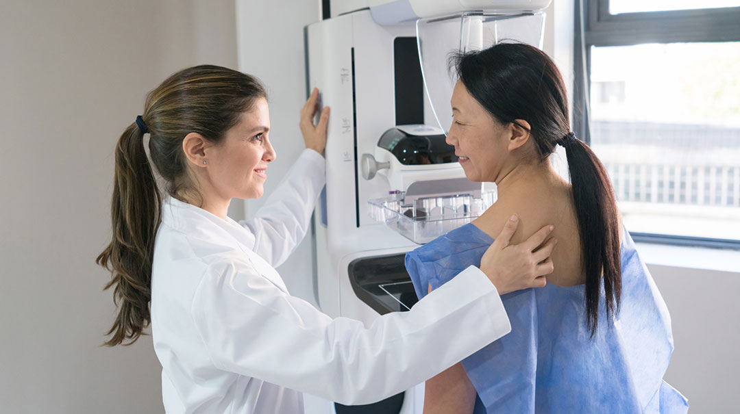 desktop_Female-women-woman-gynecologist-helping-patient-mammogram-GettyImages-917730060