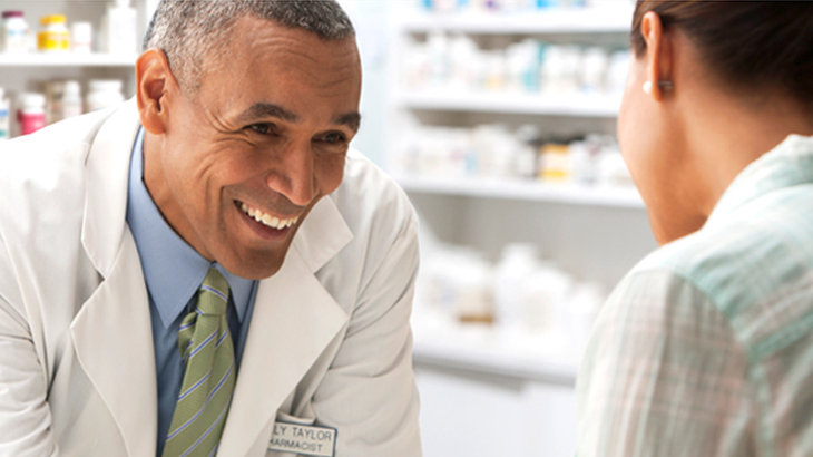 Doctor talking with patient at pharmacy