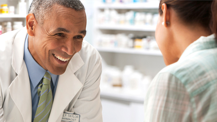 Doctor talking with patient in pharmacy
