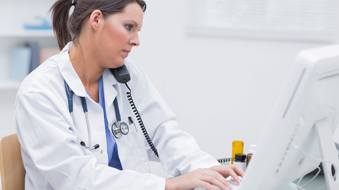 1080X605px_desktop_Female-doctor-using-computer-while-on-call-at-clinic_GettyImages-849079152