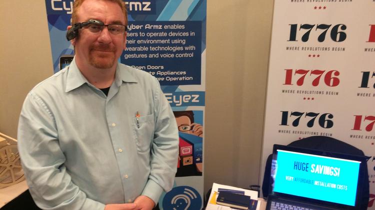 Sean Tibbetts, founder of Cyber Timez, wears Google Glass during a recent “Making Health” event hosted by MedStar Health and HHS. Among his company’s products is Cyber Eyez, an application for smart glasses that can assist the blind and visually-impaired by having any text in their environment read to them in real time using voice commands.