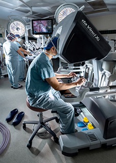 Dr. Kawano working at robotic surgery station