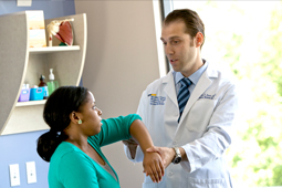 Health professional examining patient’s hand