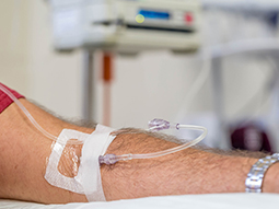 close up view of a man’s arm while having anesthesia at hospital