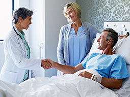 Bariatric surgeons shaking hands with patient after the surgery