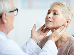 Endocrinologists examining patient’s throat
