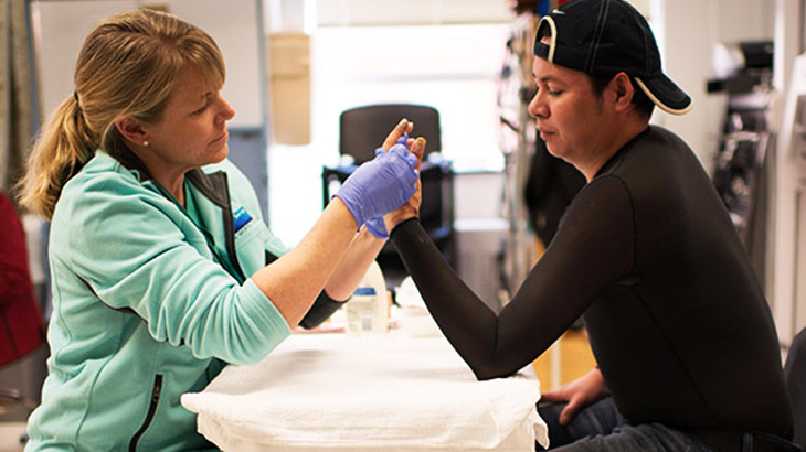 Doctor examining burn of patient