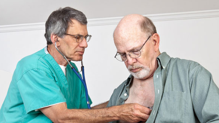 Health professional checking patient’s chest