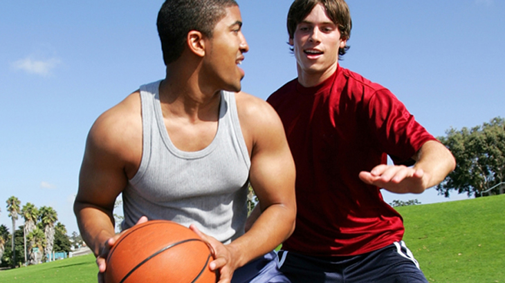 Image of two people playing basketball