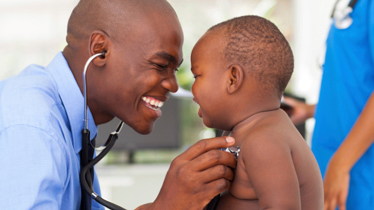 Doctor checking baby’s chest with stethescope