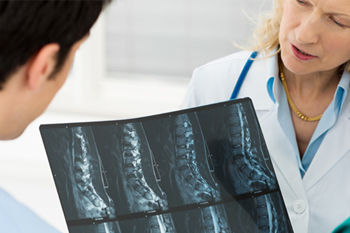 doctor’s discussing x-ray for spine