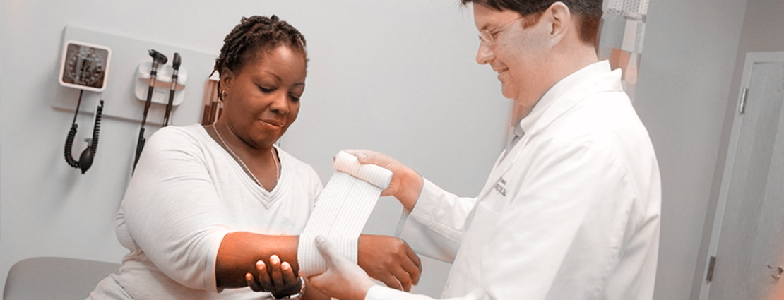 Doctor applying bandage to patient