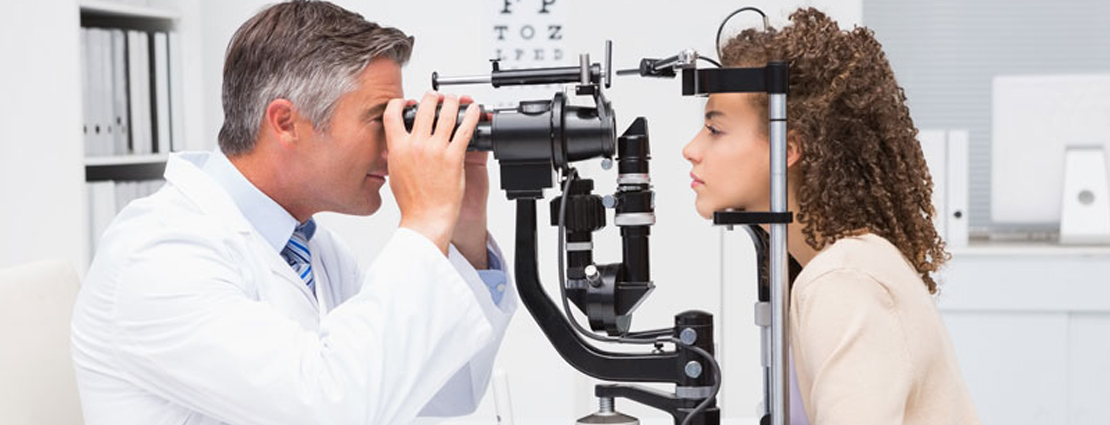 ophthalmologist checking eyes of patient