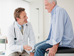 testicular specialists talking with senior patient