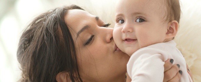 Mother kissing baby