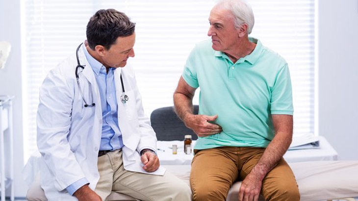 Male patient indicates to doctor pain in the side of his torso