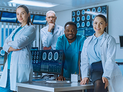 Diverse Team of Neurologist Posing with Crossed Arms in the Neurology Center Research Lab with Multiple Dispalys Showing CT / MRI Scan Images