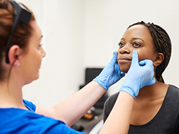 Plastic surgeon analyzing face of patient