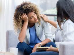 Psychiatrist performing therapy with young patient