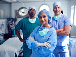Multi-Cultural Surgical Team Standing In Hospital Operating Theater