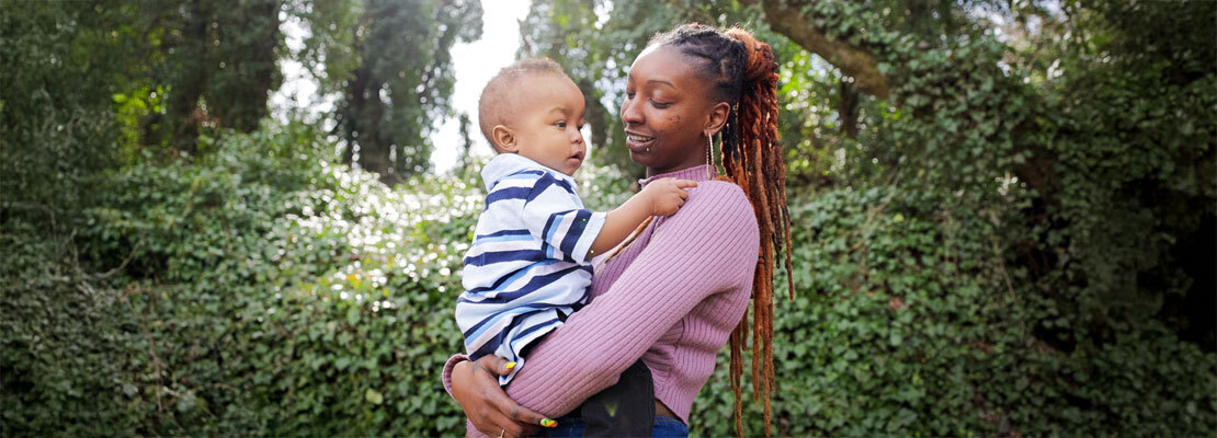 MedStar Health transplant patient Sandra Battles poses for a photo in a coffee shop. She is holding a coffee cup and smiling.