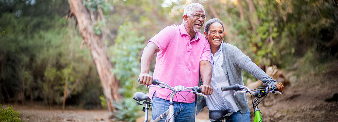 Senior man on his mountain bike outdoors in forest on a lovely summer day, staying active
