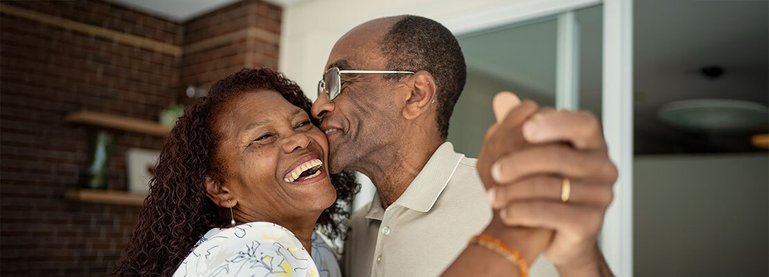 Spine surgeon and radiologist wearing protective face masks and looking at MRI scan of the spine.