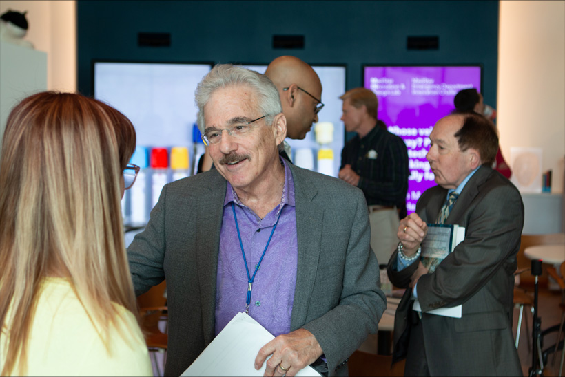Challenge finalist Elizabeth Marx (left) connecting with Challenge judge Mark Smith (right), among others networking.