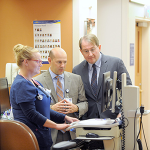 Stuart Levine, MD, FACP, consulting with medical team at MedStar Harbor Hospital.