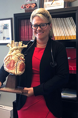 Jennifer Brown holding a model of a human heart