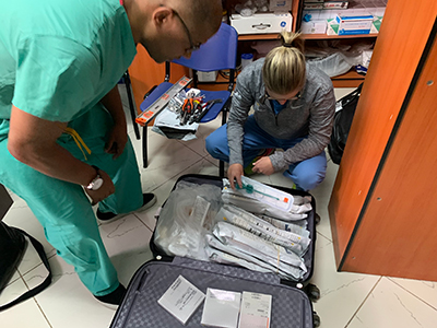 MedStar Health Dr. Wiemi Douoguih packing surgical tool for trip to Addis, Ethiopia